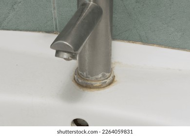 Faucet limescale. Dirty faucet with stain and limescale in bathroom. Selective focus, shallow depth of field.