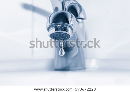 Faucet with water drop close up