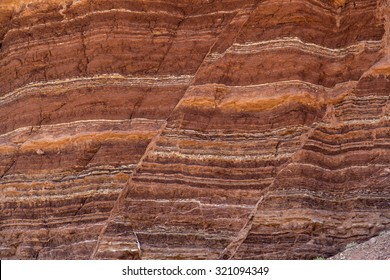 Fault lines and colorful layers in sandstone also useful as a background or texture.