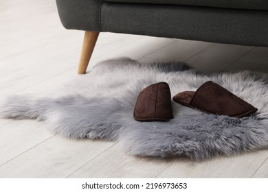 Faux Fur Rug With Slippers On Floor In Room