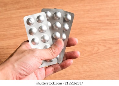 Favipiravir Tablet On Male Hand, Healthcare Concept