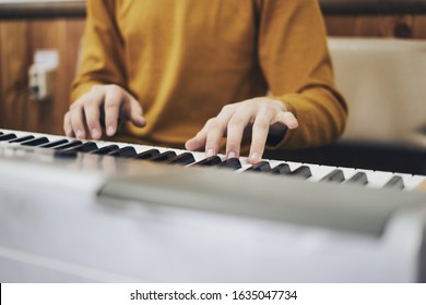 Favorite classical music Soft focus view of man hands playing a melody on piano while taking piano lessons. Musical instrument.  Piano keyboard