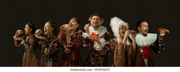 Favorite fast food tastes. Medieval people as a royalty persons in vintage clothing on dark background. Concept of comparison of eras, modernity and renaissance, baroque style. Creative collage.