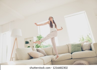 Favorite sound melody people person she her concept. Full length body size photo of cheerful glad mad unstoppable funny wife girlfriend lady standing on divan in light bright room interior