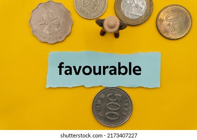 favourable.The word is written on a slip of paper,on colored background. professional terms of finance, business words, economic phrases. concept of economy. - Shutterstock ID 2173407227