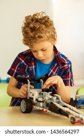 Favourite Hobby. Intelligent Cute Boy Constructing A Car While Being Alone In The Classroom