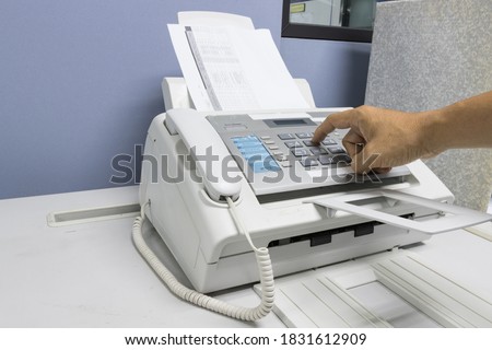 The fax machine use for Sending documents in the office, concept equipment needed in office 