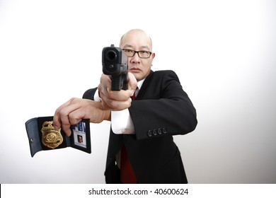 An FBI Agent With A Badge And Gun.