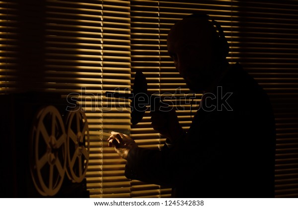FBI\
agent eavesdropping on a directional microphone\
1