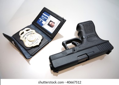 An FBI Badge And Pistol On A Table.