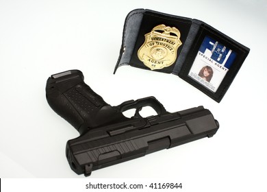 An FBI Badge And Pistol On A Table.