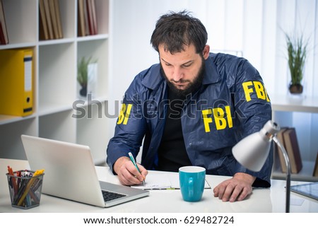 FBI man working hard at his office alone