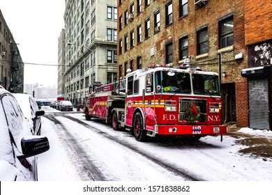 FDNY Fire Department Of New York Fire Truck In The Snow On The Street Of Brooklyn During A Winter Snowstorm Blizzard. Brooklyn, New York January 6, 2015