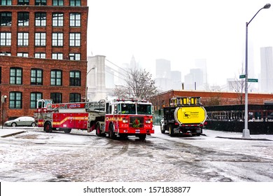 FDNY Fire Department Of New York Fire Truck In The Snow On The Street Of Brooklyn During A Winter Snowstorm Blizzard. Brooklyn, New York January 6, 2015