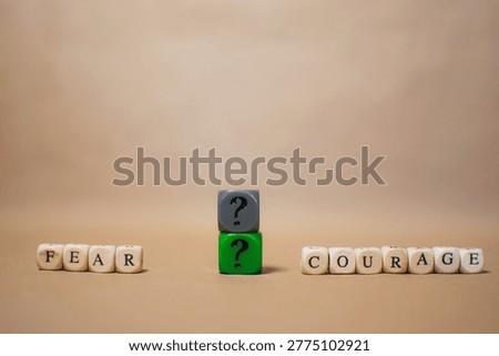 Fear and courage concept with question cube, decision making and uncertainty