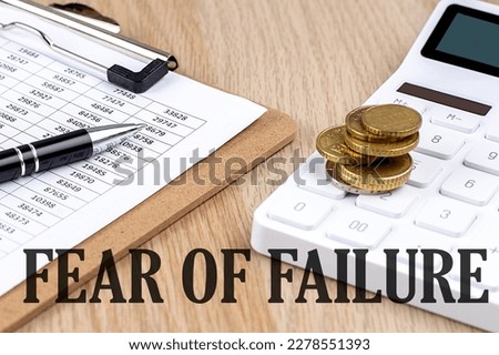 FEAR OF FAILURE text with chart and calculator and coins , business