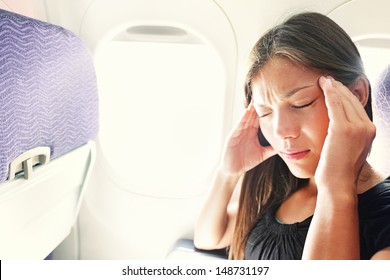 Fear Of Flying Woman In Plane Airsick With Stress Headache And Motion Sickness Or Airsickness. Person In Airplane With Aerophobia Scared Of Flying Being Afraid While Sitting In Airplane Seat.