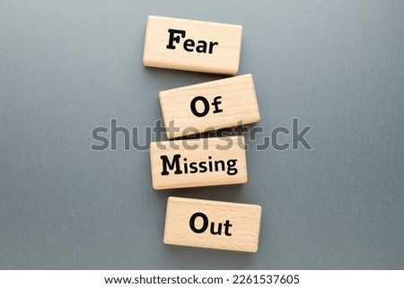Fear of Missing Out text on wooden blocks, FOMO mental health, FOMO marketing, topic