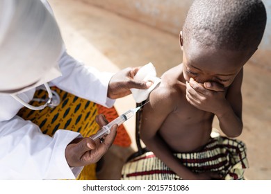 Fearful little black toddler during routine preschool vaccination in a rural village in West Africa