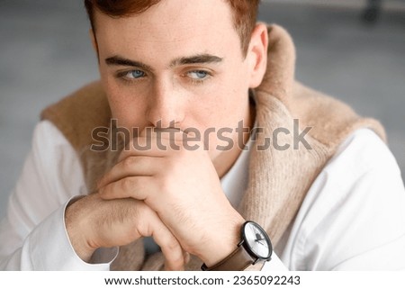 Fearful young businessman in office, closeup