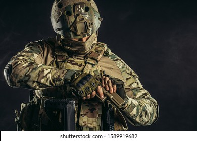 Fearless Brave Strong Man With Gun Isolated In Black Space, In Readiness To Shoot At Enemy, Wearing Military Uniform