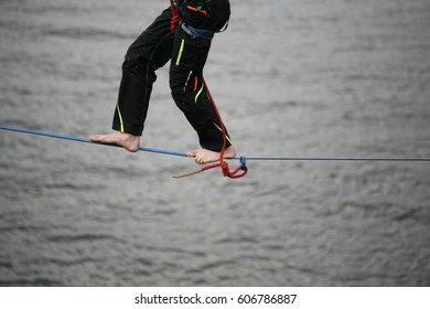 Fearless Highliner Walking On Tight Rope Above The Water