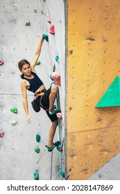 Fearless And Tenacious. Portrait Of Happy Teen Girl Climbing The Rock Wall. Sport Weekend Action In Adventure Park. Active Lifestyle Concept