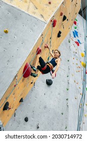 Fearless And Tenacious. Portrait Of Happy Teen Girl Climbing The Rock Wall. Sport Weekend Action In Adventure Park. Active Lifestyle Concept