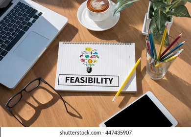 FEASIBILITY open book on table and coffee Business - Shutterstock ID 447435907
