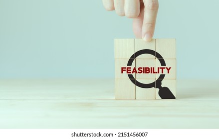Feasibility Study, Business Investment Concept. Assessing The Practicality Of A Proposed Plan Or Project For Launching A New Business Or Adopting A New Product Line.  Magnifier And Feasibility Text.