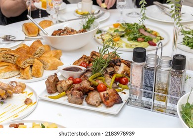 
Feast, festive food. Table with food. Pancakes, meat, cake, cabbage rolls, sweets. Beautifully set tables with food. ON white tablecloths. With white dishes. - Shutterstock ID 2183978939