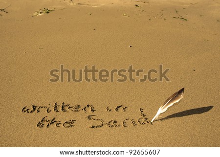 a feather used as a quill pen to write written in the sand