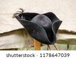 Feathered black felt hat, for man or woman, on tentpole in a military camp at a reenactment of the American Revolutionary War (1775-1783)