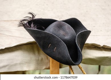 Feathered black felt hat, for man or woman, on tentpole in a military camp at a reenactment of the American Revolutionary War (1775-1783)