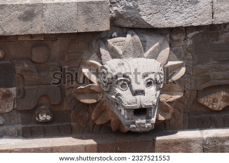 Feathered stone serpent head on the exterior of the step pyramid at Templo de Quetzalcóatl in the Teotihuacán archaeological complex in San Juan Teotihuacán, Mexico 