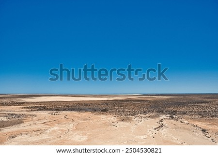 Featureless flat outback landscape between Wooramel and Overlander Roadhouse, Highway 1, Western Australia. Dried out lakes, in the distance Shark Bay

