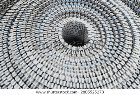 Features a close-up, top-down view of a rolled-up object, creating a striking spiral pattern.