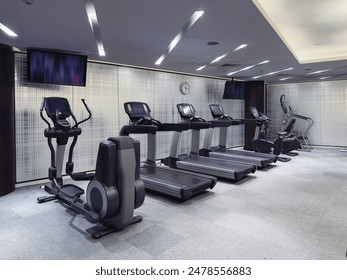 The features a modern and well-equipped gym. The gym includes a variety of exercise machines, such as treadmills, stationary bikes, ellipticals, and strength training equipment.