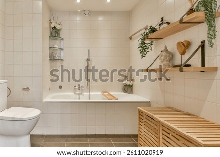 Featuring sleek lines and natural elements, this minimalist bathroom incorporates wood accents and plants for a serene atmosphere.