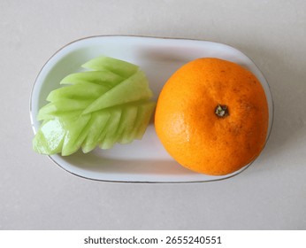 featuring two types of fruit served on an oval white plate