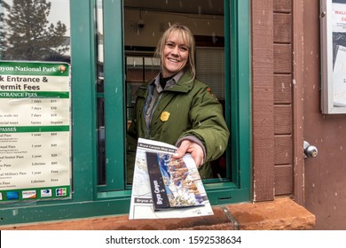 FEB 14, BRYCE NAT PARK, UTAH, USA - Female Blond National Park Ranger Hands Out Brochure Through Window At Bryce National Park, Utah