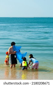 February 11, 2011, Bangsaen, Chonburi Thailand, Tourist Families Come To Swim In The Sea At Bangsaen Beach.