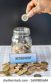 February 18 2019 - Calgary, Alberta Canada - Jar Full Of Coins Showing Retirement Savings On Spreadsheet