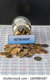 February 18 2019 - Calgary, Alberta Canada - Jar Full Of Coins Showing Retirement Savings On Spreadsheet