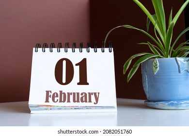 February 1st. Day 1 Of February Month, Calendar On Brown Workplace Background. Winter Time