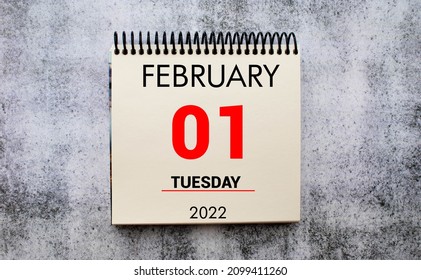 February 1st. Day 1 of February month, calendar on brown workplace background. - Shutterstock ID 2099411260