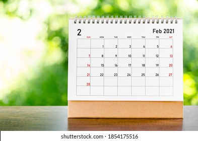 February 2021 Calendar Desk For Organizer To Plan And Reminder On Wooden Table On Nature Background.