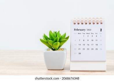 The February 2022 Desk Calendar On Wooden Table.