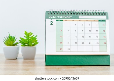 The February 2022 desk calendar on wooden background. - Shutterstock ID 2090143639
