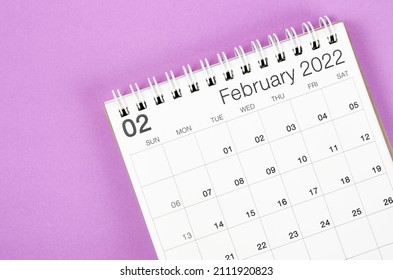The February 2022 desk calendar on light purple background. - Shutterstock ID 2111920823